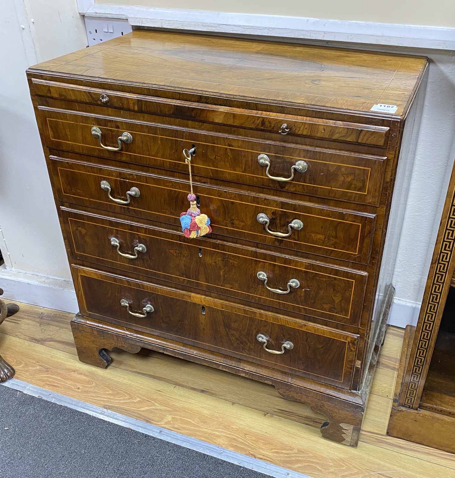 A small 18th century banded walnut four drawer chest with brushing slide, width 78cm, depth 46cm, height 82cm